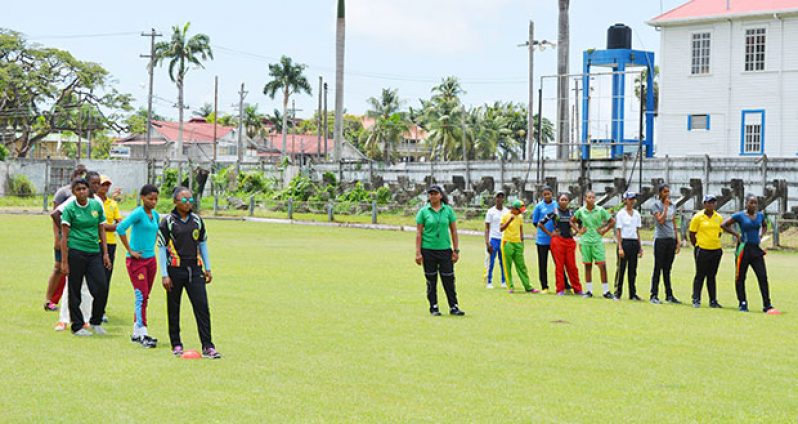 Assistant coach/manager, Devita Gobin (centre) is seen with national female Under-19 cricket squad as they are about to commence training yesterday at the Georgetown Cricket Club (GCC) ground.
