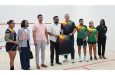 President Dr. Irfaan Ali receives a national team jersey from the President of the Guyana Squash Association, David Fernandes, after the commissioning of the international doubles courts