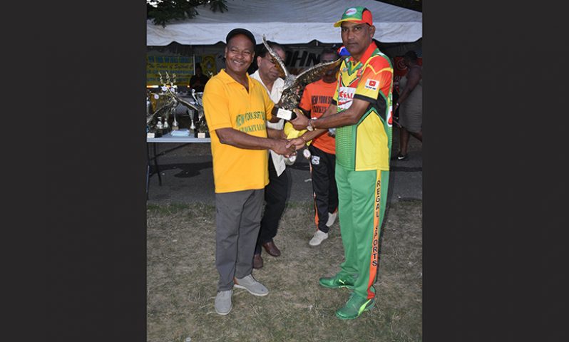 NYSCL president Eric Ferrier presents the winning trophy (Eagle) to Regal Legends skipper Mahendra Hardyal