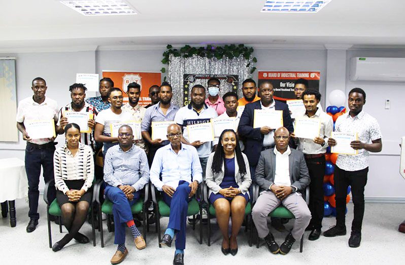 (Seated at centre) Minister of Labour, Joseph Hamilton; (seated second from left) BIT’s CEO, Richard Maughn and other officials flanked by the individuals certified in Fibre Optic Installation