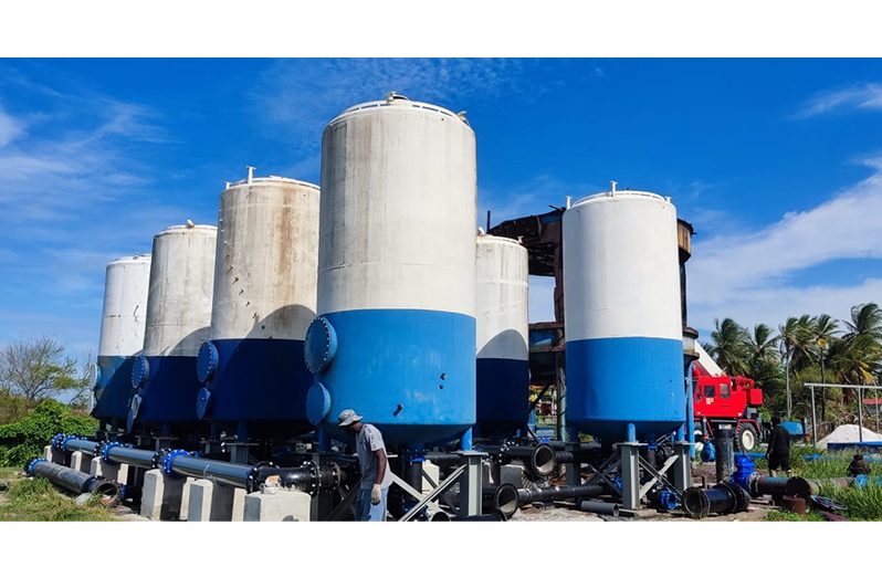 A worker looks at the pipe work on the filters installed at the Friendship water-treatment plant (GWI photo)