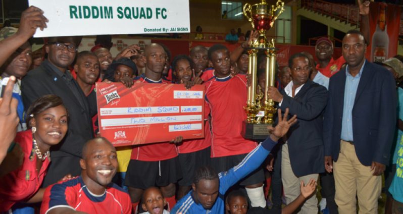 The victorious Riddim Squad side celebrate with their first GFA/Banks Beer championship trophy and prize money (Cullen Nelson Photo)