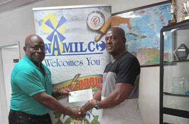NAMILCO’s Finance Executive, Mr. Fitzroy McLeod (left) hands over the sponsorship cheque to GAPLF President, Franklin Wilson