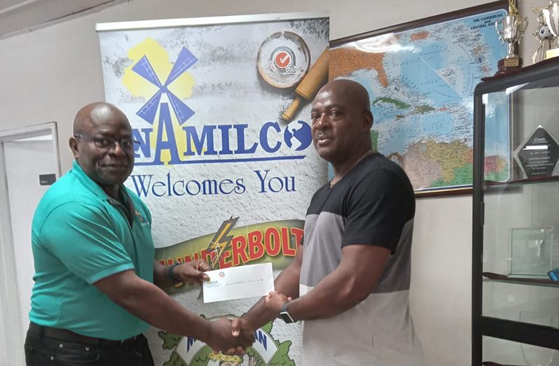 NAMILCO’s Finance Executive, Mr. Fitzroy McLeod (left) hands over the sponsorship cheque to GAPLF President, Franklin Wilson