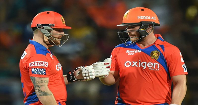 Brendon McCullum and Aaron Finch punch gloves during their 85-run opening stand.