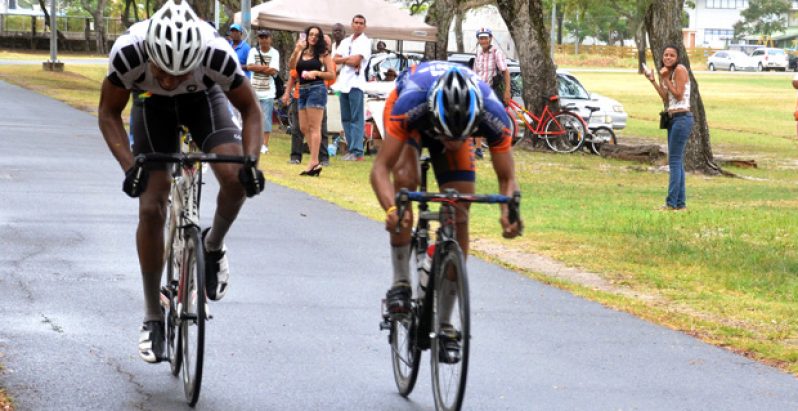 Paul DeNobrega (right) edges Marlon Williams across the finish line to win the BR Investment/Deokie Construction feature 35-lap race in the National Park yesterday. Third was Shaquile Agard (photo by Adrian Narine).