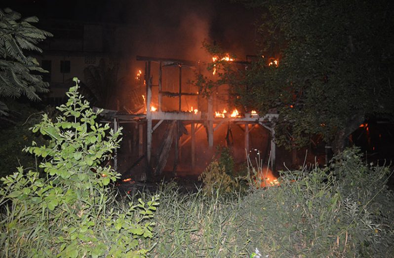 The wooden building engulfed in fire