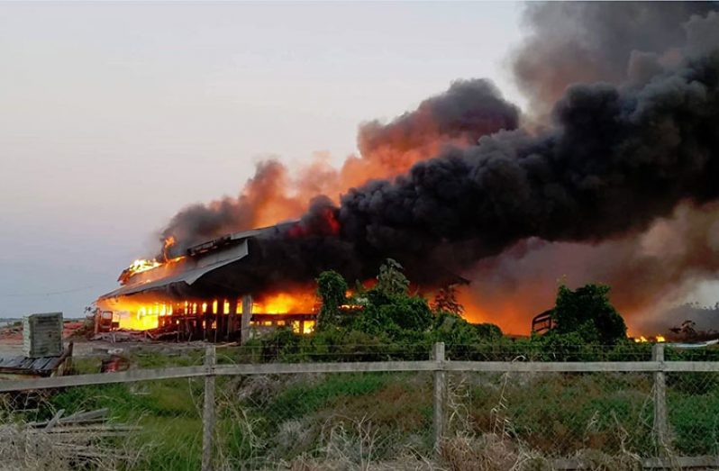The sawmill engulfed in flames
