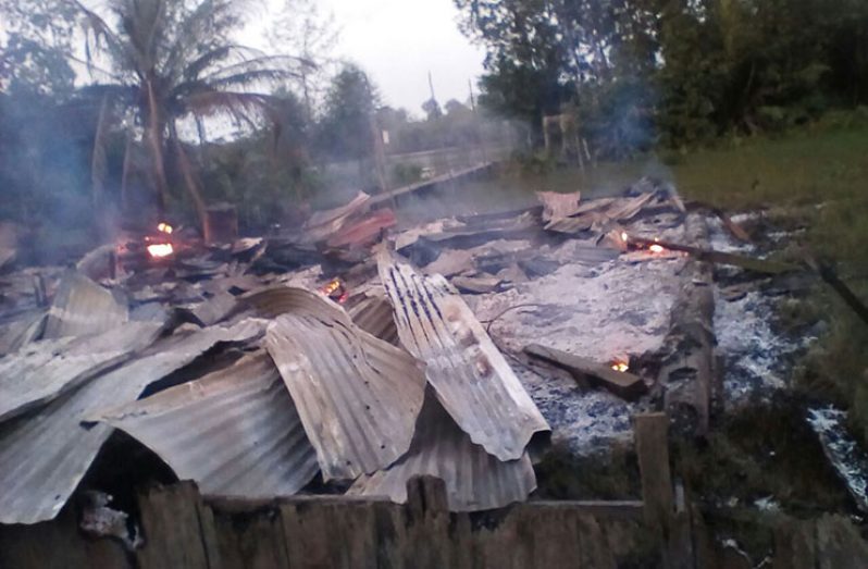 The smoldering remains of the house