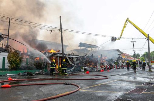 Fire fighters battle the flames during the blaze at Mae’s School (Delano Williams photo)