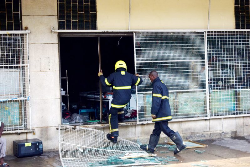 Two firefighters gain access to the lower floor of the historic shopping complex (Elvin Carl Croker photo)