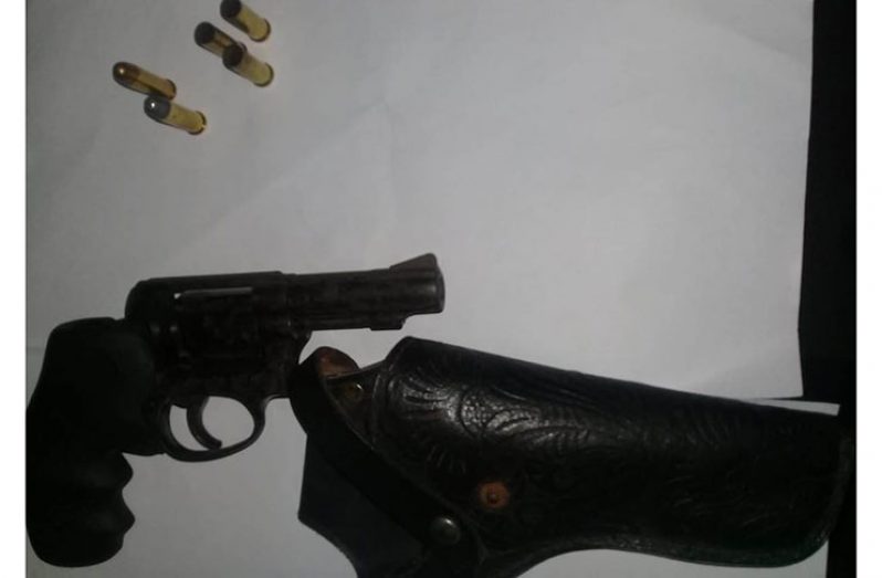 The illegal firearm, rounds and holster found in the car.