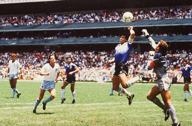 Diego Maradona scores 1st goal with his Hand of God, past England goalkeeper Peter Shilton in 1986. (Photo by Bob Thomas/Getty Images)