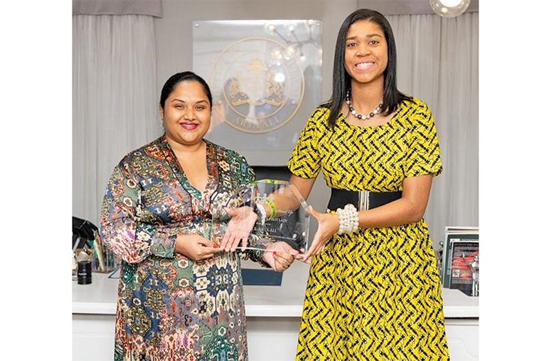 American filmmaker and education activist, Zuriel Oduwole presenting the DUSUSU award to First Lady Mrs. Arya Ali