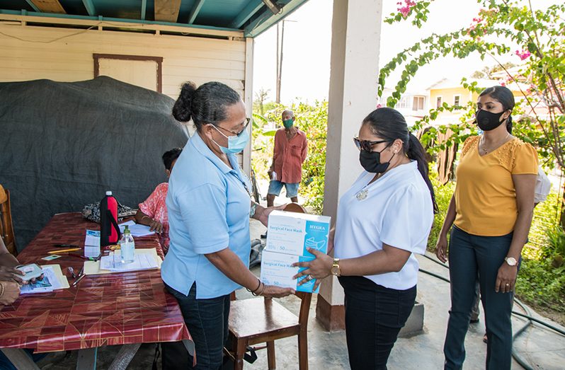 First Lady, Arya Ali, donating five boxes of masks to the Leguan Post Office where pensioners went to uplift their pension books on Monday
