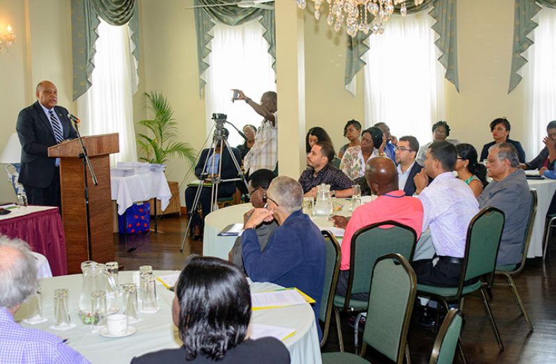 Minister of Natural Resources , Raphael Trotman , addresses participants at the opening of the seminar.