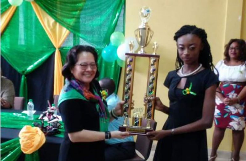 Valedictorian of the ICT programme, Dacia Caesar, as she collects her prize from Guyana’s First Lady, Sandra Granger.