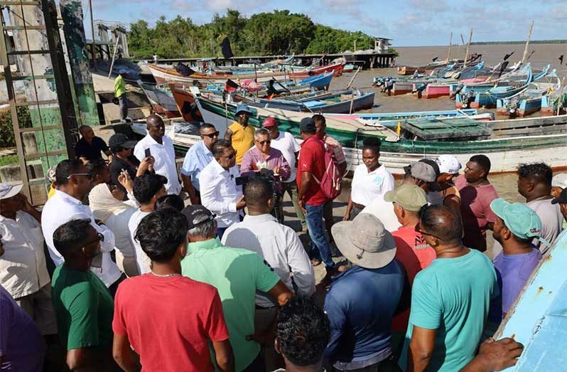 Minister of Agriculture, Zulfikar Mustapha, flanked by members of the 3 Door Fisherman Co-operative in Rosignol discusses initiatives aimed at improving the co-operative and supporting its membership