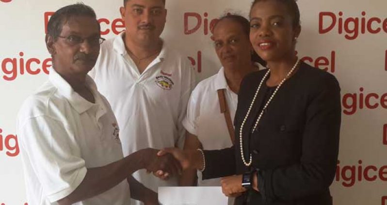 Junior Marketing Manager, Tandeika Johnson hands over the cheque to Captain of the Brass Tracker Fishing Club, Scheral Sugrim, while others look on