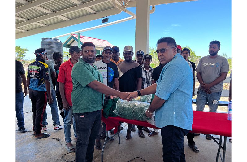 Minister of Agriculture Zulfikar Mustapha hands over the seine to the fishermen at the Albion Landing Site, Corentyne