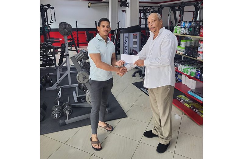 AG CARIFTA Games Team Manager, Mr. Keith Campbell (right), receives Fitness Express’ contribution from Manager, Jamie McDonald