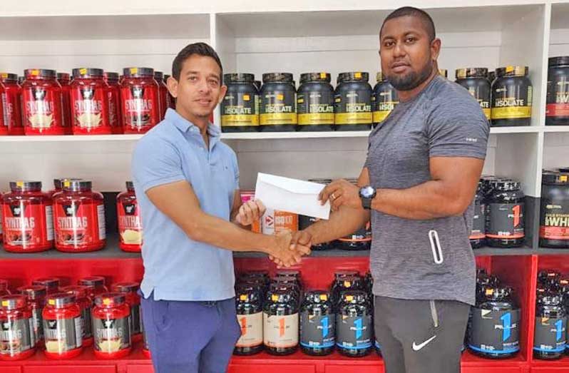 Fitness Express owner Jamie McDonald () hands over the sponsorship cheque to GBBFF Organising Secretary Videsh Sookram recently.