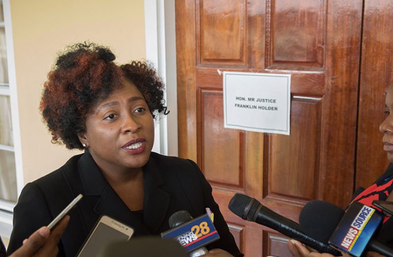 Solicitor-General Kim Kyte-Thomas informing reporters that stay of proceedings has been granted pending the hearing at determination of the Fixed Date Application later this month. 
(Photos by Samuel Maughn )