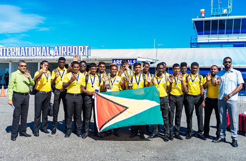 The five-time winning Guyana Under-19 team along with GCB secretary Anand Sanasie and Director of Sport, Christopher Jones, upon their arrival at the Eugene F. Correira International Airport at Ogle (Delano Williams photos)