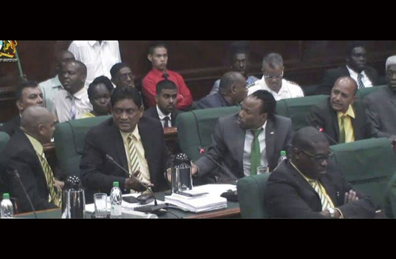 Charrandass Persaud being abused by his colleagues on his left and right minutes after he voted in favour of an Opposition-sponsored No-Confidence Motion.