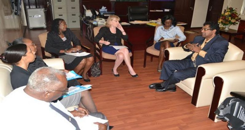 Public Security Minister, Mr. Khemraj Ramjattan (right) making a point during the meeting with UNICEF Representative Ms. Marianne Flach (and UNFPA Assistant Resident Representative Patrice LaFleur (third and fourth right, respectively) and members of their team