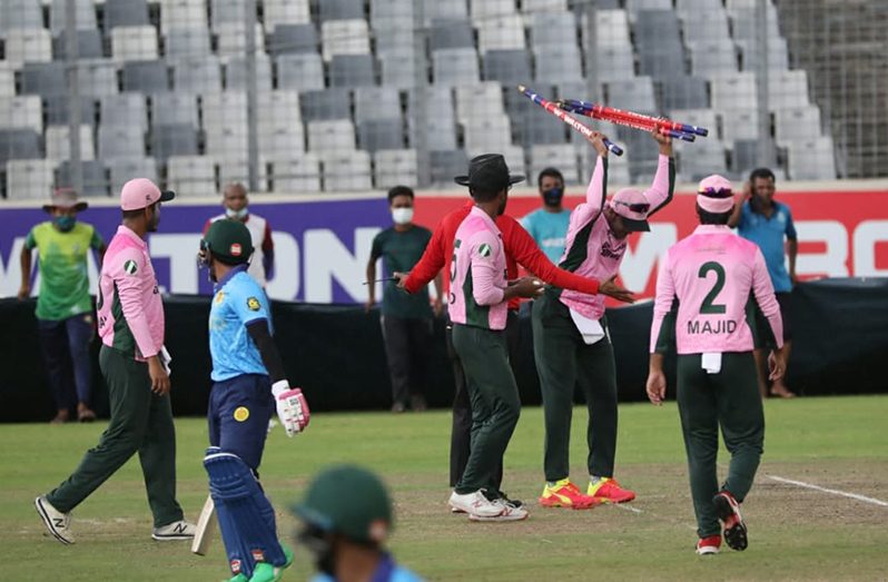 Shakib Al Hasan flings the stumps after umpire Mahfuzur Rahman calls for the covers. (Walton)