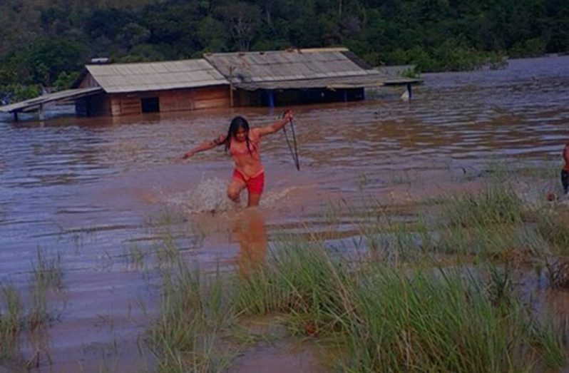 Flashback: In this photo, a young lady from Kanapang is making her way to safety.