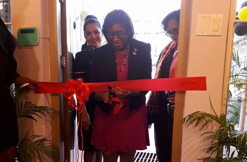 Minister of Public Telecommunications, Cathy Hughes, cuts the ribbon to formally open the Fly Jamaica Georgetown Office.