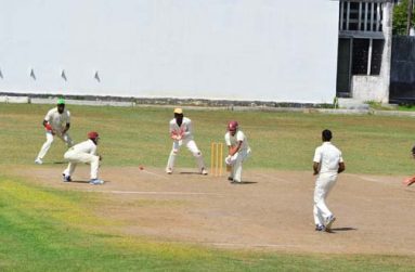 Well played Johnny! Jonathan Foo of Johnson’s XI plays a forward defensive shot against the bowling of Amir Khan (foreground) yesterday, while from left, Shimron Hetmyer, Steven Jacobs, Jason Sinclair (wkp.) and Tagenarine Chanderpaul look on. (Photo by Adrian Narine)