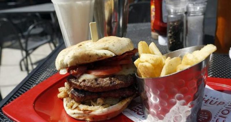 A meal of a ''Monster''-sized A.1. Peppercorn burger, Bottomless Steak Fries, and Monster Salted Caramel Milkshake is seen at a Red Robin restaurant in Foxboro, Massachusetts July 30, 2014.