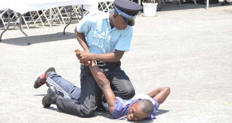 A Police recruit demonstrates an arrest technique