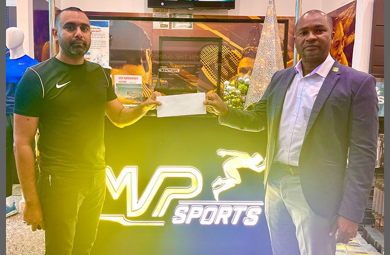 Ian Ramdeo (left) of MVP Sports presents the sponsorship to GFF president Wayne Forde