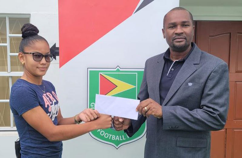Annalisa Vincent accepts her U.S. college scholarship letter from GFF president Wayne Forde