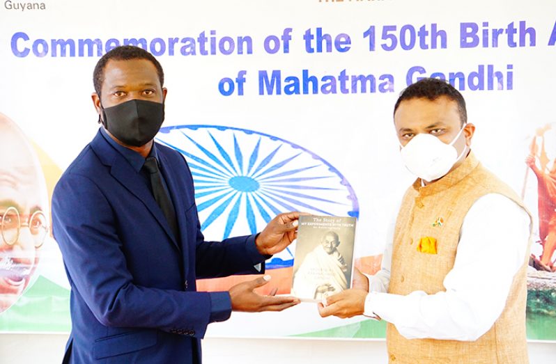 Foreign Affairs Minister, Hugh Todd, was gifted the auto biography of Gandhi, “The story of my experience with truth” and a commemorative stamp to mark the 150th birth anniversary of Gandhi that was issued by the Guyana Post Office Corporation (Carl Croker photo)