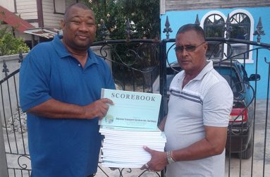 Hilbert Foster hands over donation to UCCA president Dennis De Andrade.