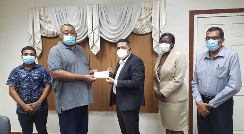 BCB President, Hilbert Foster, accepts the sponsorship cheque from Minister of Agriculture, Zulfikar Mustapha, in the presence of BCB PRO, Simon Naidu and Permanent Secretary, Ms. Nedd.