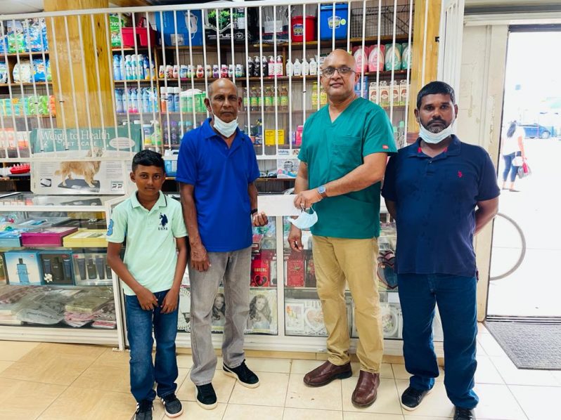 Poonai Bhigroog hands over sponsorship to RHTYSC Organising Secretary/Cricket Manager Ravindranauth Kissoonlall in the presence of Tameshwar Deoanand and Tyrone Pottaya.