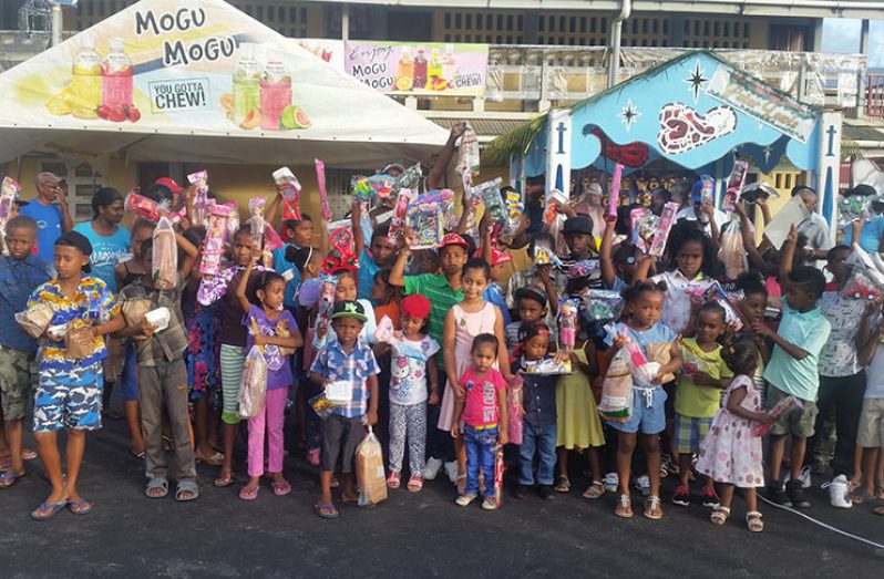 Some of the children attending the Christmas Party posed with their goody-bags and toys.