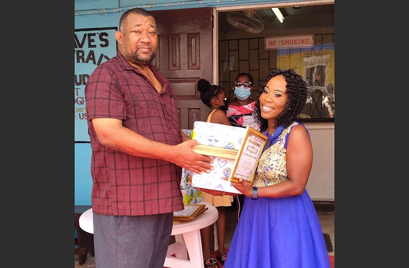 BCB president Hilbert Foster hands over the Brian Ramphal Mother-of-the-Year 2022 Award to Johonel Munroe