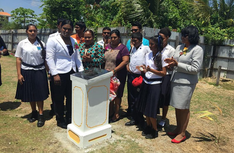 Students and education officials at the unveiling of the plaque to launch the foundation