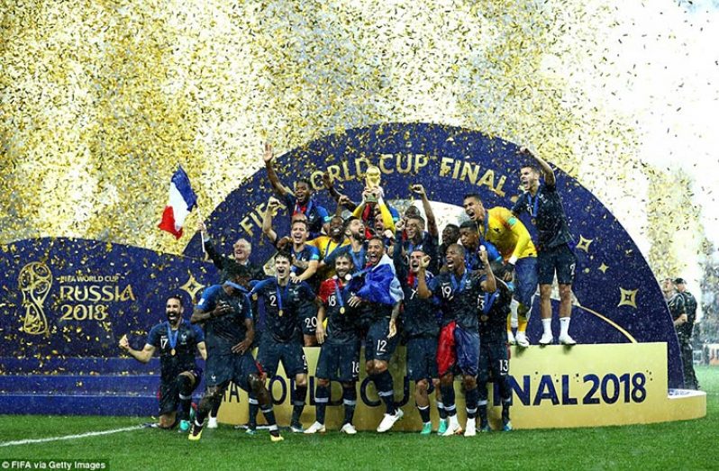 Hugo Lloris of France lifts the World Cup trophy to celebrate with his team-mates as the rain pours down in Moscow.(FIFA via Getty Images)