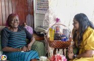 Centenarian Francis Azore with a Ministry of Human Services and Social Security representative when she was honoured for her extraordinary milestone