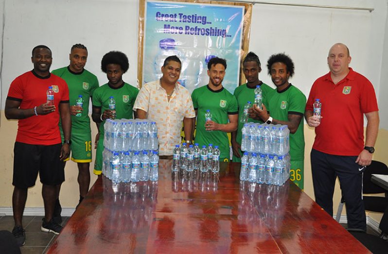 CEO of Sureia Manufacturing Inc. Frank Sanicharra (4th left) with Golden Jaguars captain, Samuel Cox (4th right) and teammates, along with TD Ian Greenwood (right) and Head Coach Michael Johnson (left) during the presentation.