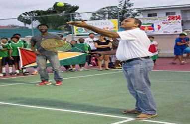 Minister of Sport, Dr Frank Anthony offers the Ceremonial Serve to signal the start of the Inter-Guiana Games Tennis Tournament.