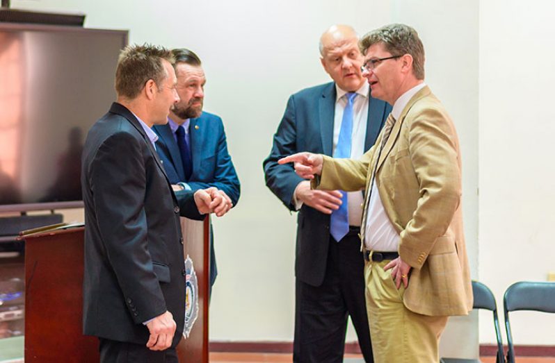 British High Commissioner to Guyana, Greg Quinn (right) engages Irish Financial Investigations adviser to SOCU, Dr Sam Sittlington (left) as the two British anti-corruption and fraud experts look on